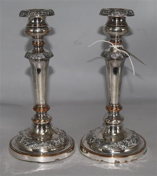 A pair of embossed plated candlesticks